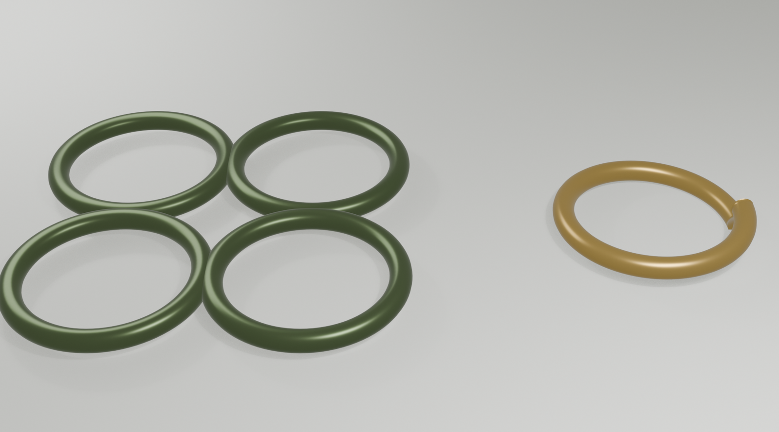 Four closed sage-colored stainless steel jump rings and one open gold ring on a moss background